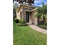 Home's exterior features stone facade and walkway at 4759 Lathloa Loop, Lakeland, FL 33811