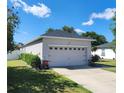 Single-story home featuring a two car garage, trimmed hedges, and a freshly cut lawn at 2158 Mirasol Dr, Winter Haven, FL 33881