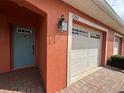 Inviting home exterior with a charming teal door and well-maintained garage at 1202 Ashton Palms Dr # 6, Lake Wales, FL 33859