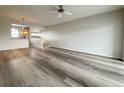 Bright living room featuring modern wood-look flooring and a ceiling fan at 1202 Ashton Palms Dr # 6, Lake Wales, FL 33859