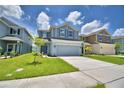 Two-story home featuring well-manicured lawns and complementary landscaping at 1476 Leamington Lane, Winter Haven, FL 33884