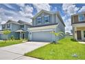 A two-story home features a well-maintained lawn and a spacious driveway at 1476 Leamington Lane, Winter Haven, FL 33884