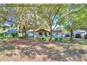 Lovely single-story home featuring a quaint front porch, mature trees, and vibrant curb appeal at 3365 Bahama Ct, Lake Wales, FL 33898