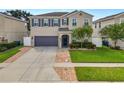 Two-story house with a two car garage and landscaped lawn at 3537 Julius Estates Blvd, Winter Haven, FL 33881