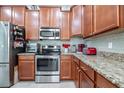 Modern kitchen with stainless steel appliances and granite countertops at 4104 Martindale Loop, Winter Haven, FL 33884