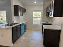 Modern kitchen with dark brown cabinets and a breakfast bar at 833 3Rd Ave, Waverly, FL 33877