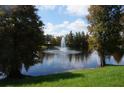 Serene community pond with a central fountain at 3832 Traditions N Blvd, Winter Haven, FL 33884