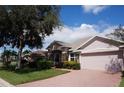 One-story home with a two-car garage and well-manicured lawn at 3832 Traditions N Blvd, Winter Haven, FL 33884