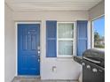 Bright blue front door with matching shutters and a grill on the porch at 720 S Morrison Ave, Fort Meade, FL 33841