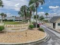 Lake Henry Estates entrance sign surrounded by lush landscaping, secured by gated access at 627 Watercrest Dr, Haines City, FL 33844