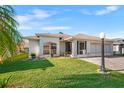 Charming home features lush lawn, well-maintained landscaping, and a brick driveway leading to a two-car garage at 627 Watercrest Dr, Haines City, FL 33844
