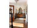 Bright foyer with a wood floor, chandelier, antique mirror, and decorative console table at 2300 Scenic N Hwy # 51, Lake Wales, FL 33898