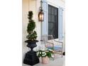 Charming front porch with a wicker chair, garden container, and classic outdoor lantern at 2300 Scenic N Hwy # 51, Lake Wales, FL 33898