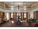Grand living room featuring a soaring ceiling, Juliet balcony, and ornate area rug at 2300 Scenic N Hwy # 51, Lake Wales, FL 33898