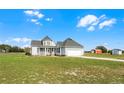 Wide shot of a beautiful two-story house with a large front lawn and adjacent barn at 4071 Albritton Rd, St Cloud, FL 34772