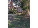 View of the backyard with a storage shed and chain link fence at 5017 Cornell St, Lakeland, FL 33810