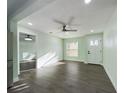 Living room featuring wood-look flooring, light green walls, and an open doorway at 2002 Sutton Rd, Lakeland, FL 33810