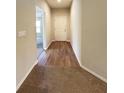 Bright hallway with light-colored walls, wood-look flooring, and carpet at 222 Cattail Way, Lake Alfred, FL 33850