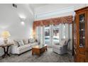 Cozy living room with plush carpeting, and sliding glass doors to the pool at 324 Hamilton Shores Ne Dr, Winter Haven, FL 33881