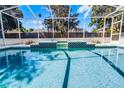 Inviting screened-in pool area with tiled accents and clear blue water at 324 Hamilton Shores Ne Dr, Winter Haven, FL 33881