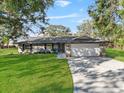 Attractive one-story home with a large front yard, a two-car garage, and a classic, timeless design at 4570 Chambliss Rd, Winter Haven, FL 33884