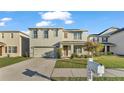 Two-story house with light beige siding, a two-car garage, and a mailbox at 935 Waterville Dr, Auburndale, FL 33823