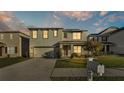 Two-story house exterior with gray siding, and a two-car garage at 935 Waterville Dr, Auburndale, FL 33823