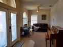 Bright living room features arched windows, a ceiling fan, and comfortable seating at 2712 Oak Hammock Loop, Mulberry, FL 33860