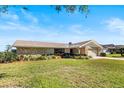 Attractive single-story home with stone details, mature landscaping, and a spacious front yard at 288 Hernando Rd, Winter Haven, FL 33884