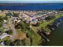 Aerial shot of the property showing proximity to a lake, docks, and the surrounding residential neighborhood at 4027 Island Lakes Dr, Winter Haven, FL 33881