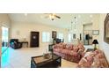 Open-concept living room featuring tile floors, vaulted ceilings, and abundant natural light at 4101 Limerick Dr, Lake Wales, FL 33859
