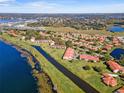 Wide aerial view of the community showcasing beautiful lakes, canals and meticulously maintained grounds at 802 Magnolia Pl, Winter Haven, FL 33884