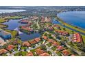 Community aerial view highlighting lakes, green spaces, and residences with terra cotta roofs at 802 Magnolia Pl, Winter Haven, FL 33884