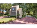 Welcoming entrance to Winterset community with landscaped grounds at 802 Magnolia Pl, Winter Haven, FL 33884