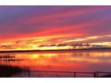 Water view showcasing a vibrant sunset with colorful reflections and peaceful scenery at 1769 S Lake Reedy Blvd, Frostproof, FL 33843
