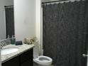 Clean bathroom with granite countertop and dark-colored vanity at 3329 Lounging Wren Ln, Bartow, FL 33830