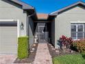 Brick walkway leading to the front door, featuring a screened entryway and lush landscaping at 4076 Tralee Dr, Lake Wales, FL 33859