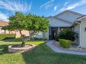 Landscaped front yard with mature trees and brick walkway at 4089 Dunmore Dr, Lake Wales, FL 33859