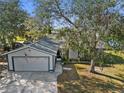 Two-car garage home with a tree-lined yard at 1143 Waterview Pt, Lakeland, FL 33801