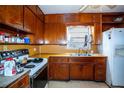 Small kitchen with wood cabinets and appliances at 1329 Mount Pisgah Rd, Fort Meade, FL 33841