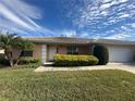 Tan house exterior with a white door and garage at 137 Harbor Way, Auburndale, FL 33823