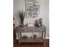 Entryway console table with gray finish and decorative items at 1371 Tuscan Ter # 3403, Davenport, FL 33896