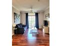 Living room with dark gray sofa, wood floors, and balcony access at 1371 Tuscan Ter # 3403, Davenport, FL 33896