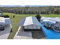 Single story home with metal roof and carport, surrounded by other homes at 1750 Fox Hill Dr, Lakeland, FL 33810
