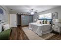 Main bedroom with wood floors, sliding barn door, and a comfy bed at 2104 John Arthur Way, Lakeland, FL 33803