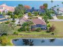 Beautiful aerial view of the home showcasing the large lot, pond, and screened-in pool at 221 Mclean Pt, Winter Haven, FL 33884