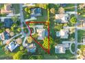 Aerial view of property featuring screened pool, mature landscaping and circular driveway on a cul-de-sac street at 2428 Wildwood Ct, Winter Haven, FL 33884