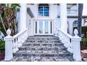 Elegant entryway with double doors and a tiled staircase at 3001 Crystal Beach Rd, Winter Haven, FL 33880