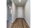 Long hallway with dark brown tile floors at 3285 Weitzel Dr, Haines City, FL 33844