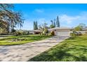 House exterior with a large front yard and driveway at 38 Grenewood Ln, Haines City, FL 33844